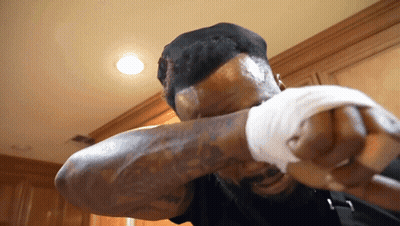 Man With Tattoo Holding Fist Up GIF