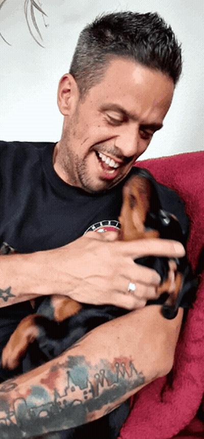 Man With Tattoo Holding Puppy GIF