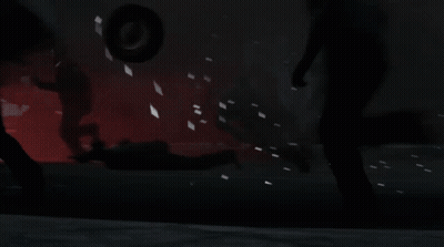 Man With Tattoo In Dark Room With Other Men GIF
