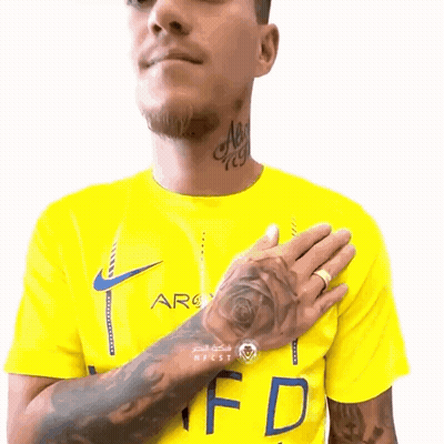 Man With Tattoo In Yellow Shirt With Letter F GIF