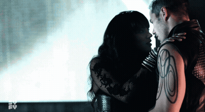 Man With Tattoo Kissing Woman In Dark Room GIF