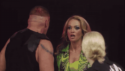 Man With Tattoo Next To Woman In Green Outfit GIF