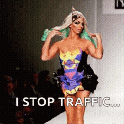 Man With Tattoo Next To Woman In Green Outfit GIF