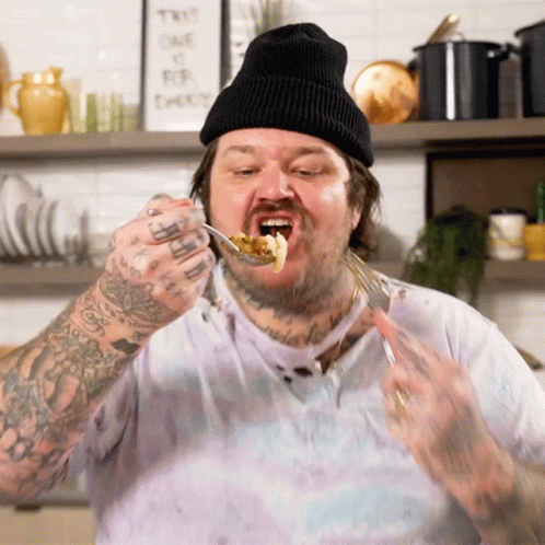 Man With Tattoo On Arm Eating Food GIF