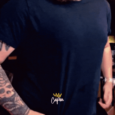 Man With Tattoo On Arm Saying Capon On Sleeve GIF