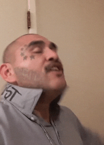 Man With Tattoo On Face Has Word Jeeee GIF