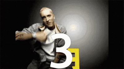 Man With Tattoo Pointing To Number Three GIF