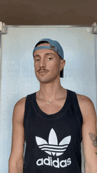 Man With Tattoo Shrugs GIF
