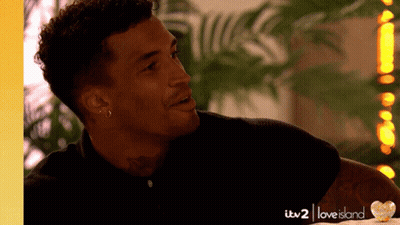 Man With Tattoo Smiling In Love Island Ad GIF