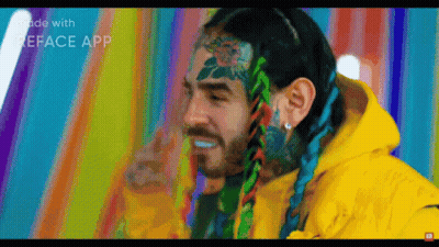 Man With Tattoos On Face In Yellow Jacket GIF