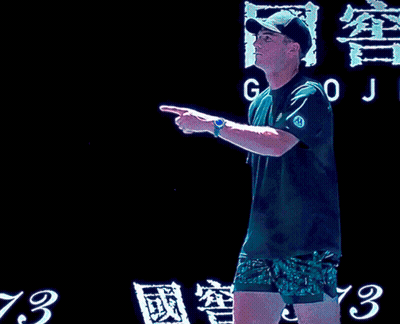 Man With Tennis Racquet And Woman In Green Dress GIF