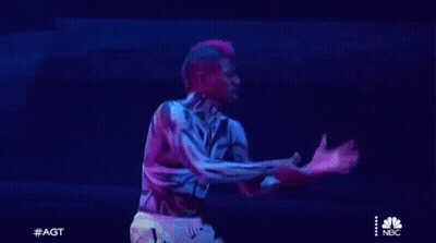 Man With Tiger Body Paint Holding Sword On Stage GIF
