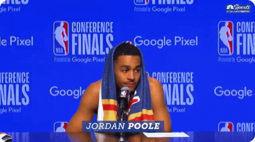 Man With Towel On Head In Front Of Google Pixel Conference Finals Sign GIF
