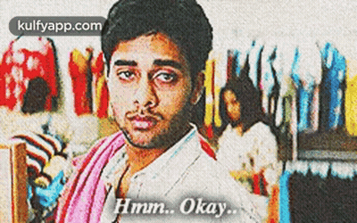 Man With Towel Says Hmm Okay In Front Of Clothes GIF