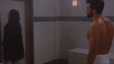 Man With Towel Standing Next To Woman GIF