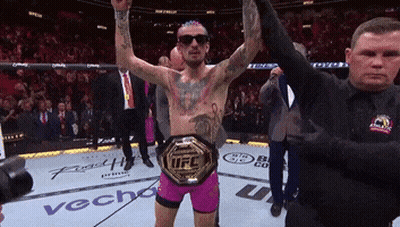 Man With UFC Belt In Wrestling Ring GIF