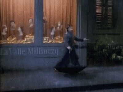 Man With Umbrella At La Valle Millnery GIF