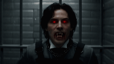 Man With Vampire Teeth And Red Eyes GIF
