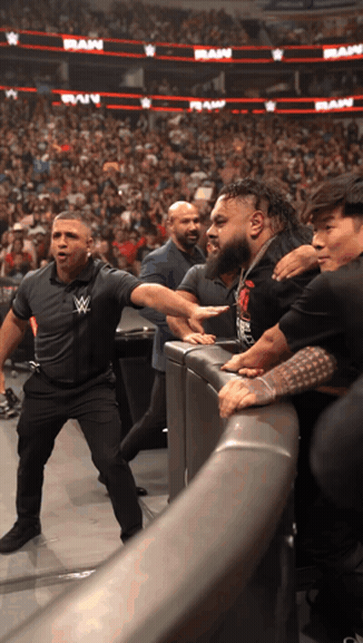 Man With W Logo Shirt At Wrestling Event GIF