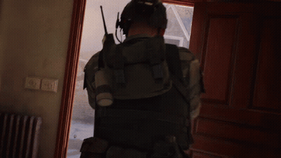 Man With Walkie Talkie Standing In Doorway GIF