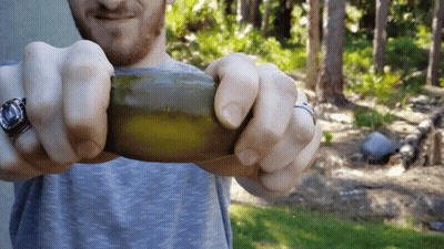 Man With Watch And Ring Holding Green Object GIF