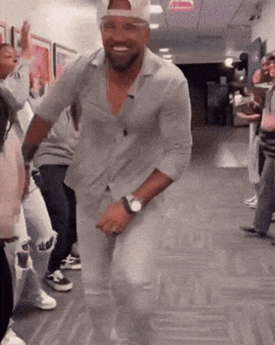 Man With Watch Dancing In Hallway With Others GIF