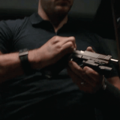 Man With Watch Holding Gun GIF