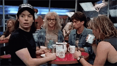 Man With Wayne Reynolds Hat At Table With Others GIF