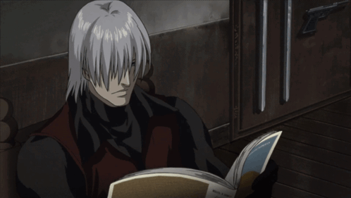 Man With White Hair Reading Foreign Language Book GIF