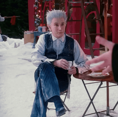 Man With White Hair Sitting At Table With Coffee GIF