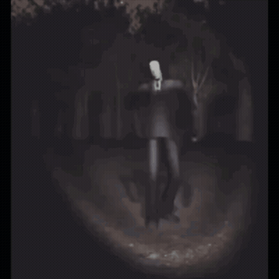 Man With White Head Standing In Dark Forest GIF