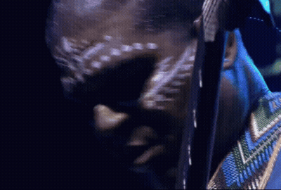 Man With White Paint On Face Looking Down GIF