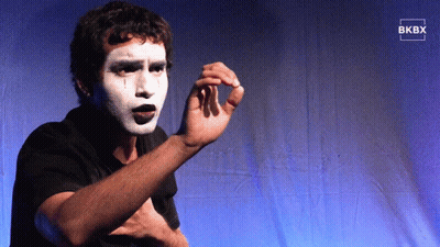 Man With White Paint On Face Standing Before Blue Curtain Saying BKBY GIF