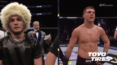 Man With Wig And Shirtless Man In Boxing Ring GIF