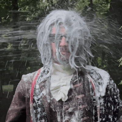 Man With Wig And Sunglasses Covered In Soap GIF