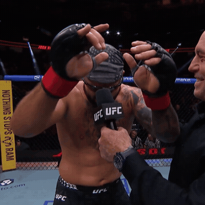 Man With Wig And Sunglasses In Front Of UFC Sign GIF