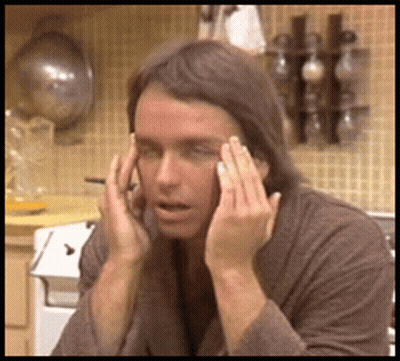 Man With Wig And Sunglasses Watching Man In Headphones GIF