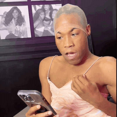 Man With Wig Looking At Phone GIF