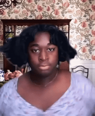 Man With Wig Making Funny Face Flower Wall GIF