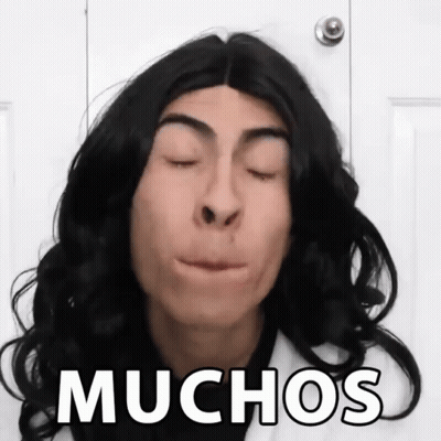 Man With Wig Saying Muchos GIF