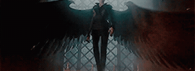Man With Wings Standing In Dark Room With Cane GIF