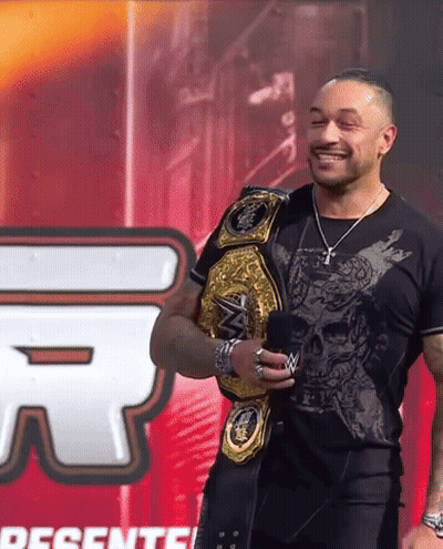 Man With Wrestling Belt And Presente Sign GIF