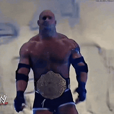 Man With Wrestling Belt Standing In Front Of N Sign GIF
