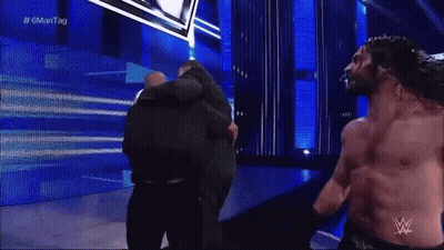 Man With Wrestling Logo On Shirt Close Up GIF