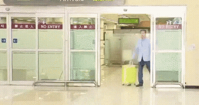 Man With Yellow Suitcase At No Entry Gate GIF