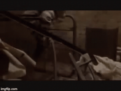 Man Without Shirt Arms Outstretched In Dark Room GIF