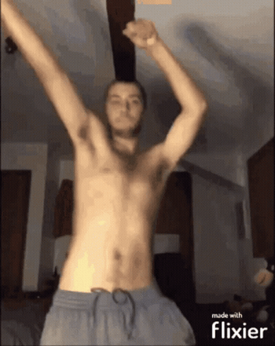 Man Without Shirt Dancing Under Ceiling Fan GIF