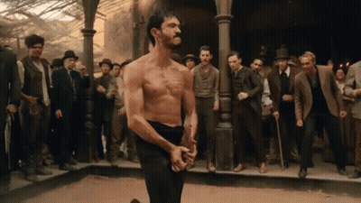 Man Without Shirt Facing Crowd Of Men GIF