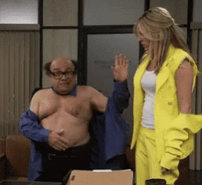 Man Without Shirt Helped By Woman In Yellow Suit GIF