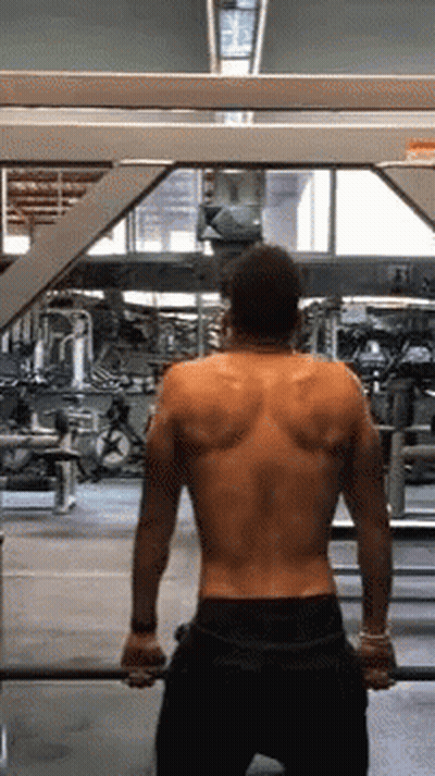Man Without Shirt Holding Barbell In Gym GIF